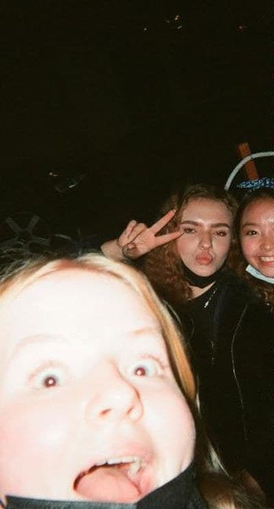 Three friends taking a flash selfie at night